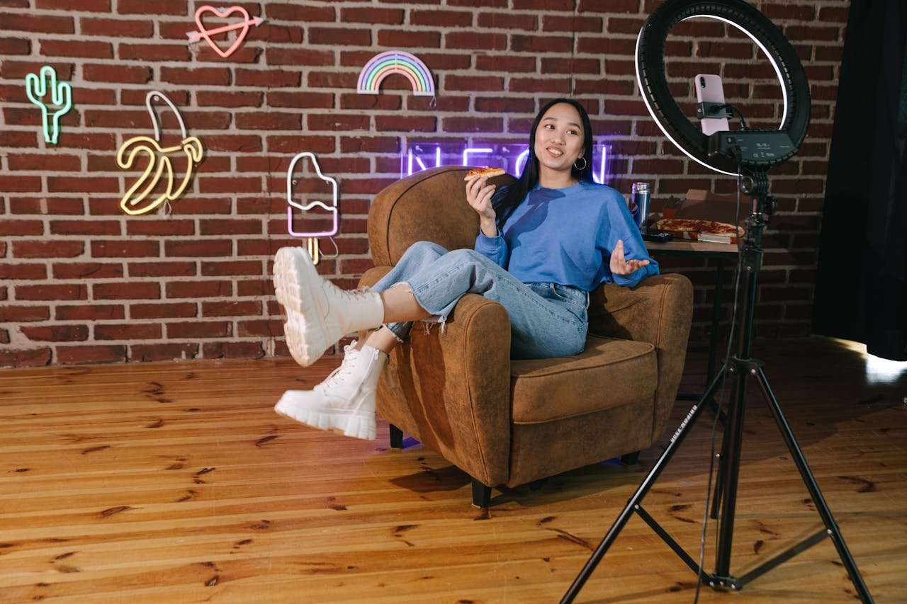 A Woman Recording Herself with a Smartphone while  Eating